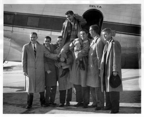University of Kentucky; Basketball; Seven young men in front of an airplane