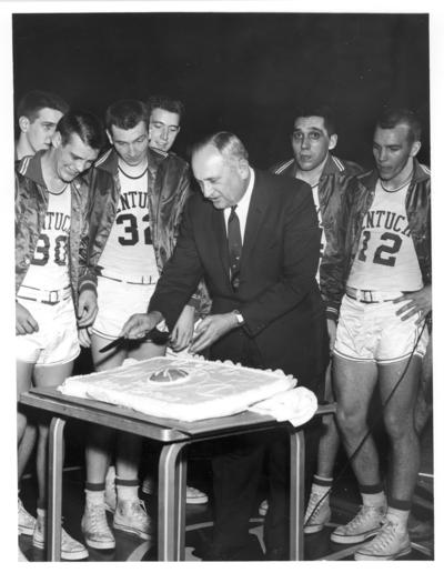 University of Kentucky; Basketball; Rupp cuts the cake in front of the basketball players