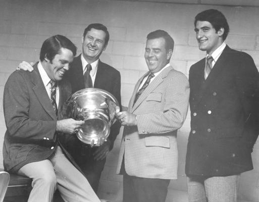 University of Kentucky; Basketball; Four men appreciate a trophy
