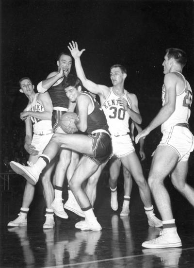 University of Kentucky; Basketball; UK vs. [Unknown]; An opponent crouches over a rebound