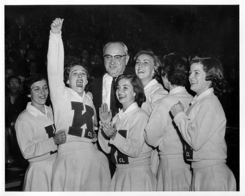 University of Kentucky; Cheerleaders; Six cheerleaders stand with Adolph Rupp