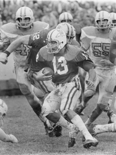 University of Kentucky; Football; Game Scenes; Player #13 looks for traction on a muddy field