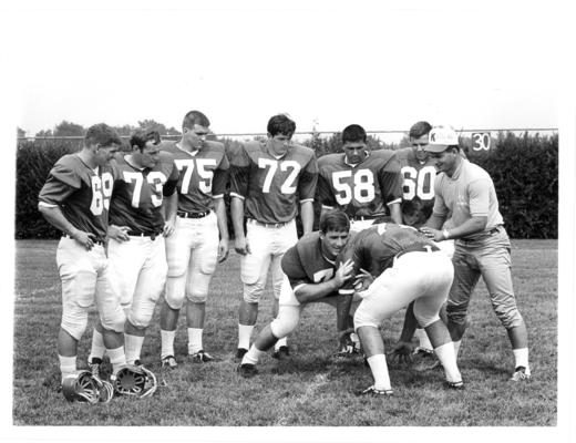 University of Kentucky; Football; Small Group & Team; A coach and six football players observe a drill