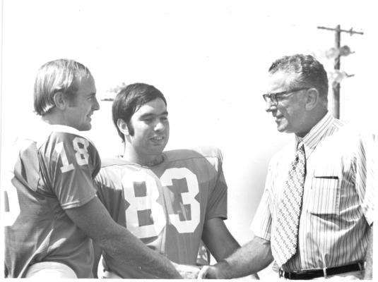 University of Kentucky; Football; Small Group & Team; A coach and two football players (#18 and #83)