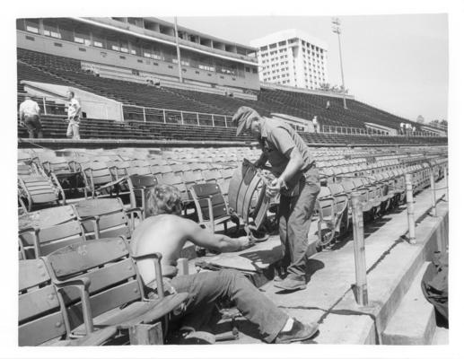 University of Kentucky; McClean Stadium; Demolition; Two men working on a seat in stadium