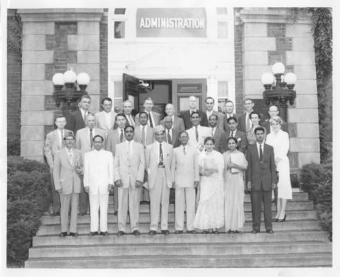 University of Kentucky; Miscellaneous; A group photo in front of the administration building; (Front: Awal, Sherwani, Sapra, Auub, Majummdar, Miss Shams, Mrs. Khanum, Bokhari; 2nd: Whitehouse, Manhew, Dr. Brown, Hanif, Ali, Khan, Faiz, Ahmad)