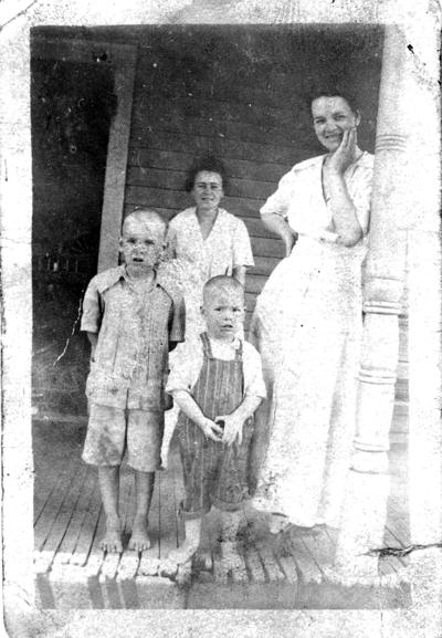 Family and Friends; Two boys and two woman standing at the porch