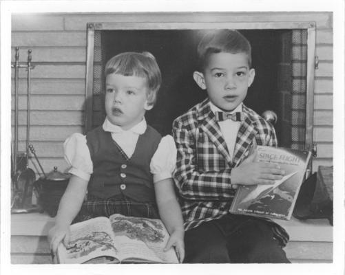 Family and Friends; Two children hold their books