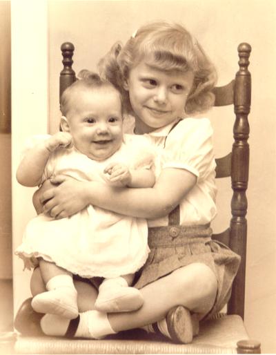 Babies; Older sister holds baby in lap