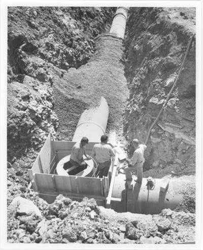 West Hickman Creek Interceptor Sewers; Construction; Three men working on a manhole