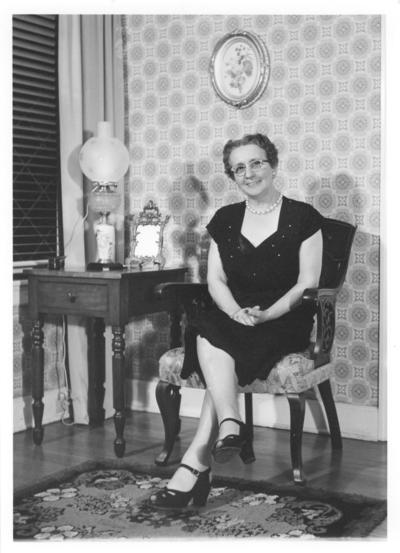 Women; Individual; Unidentified; An older woman, sitting in a chair