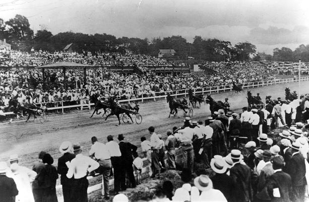 Horses; Harness Racing; Race Scenes; Crowd standing beside the racetrack