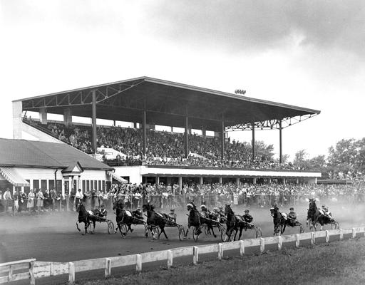 Horses; Harness Racing; Race Scenes; Racers in front of the grand stand