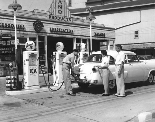 Malone's Service Station; Gas Station Attendant pumping gas for a woman and man