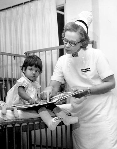 Cardinal Hill Hospital; Nurse and young girl look at a picture book