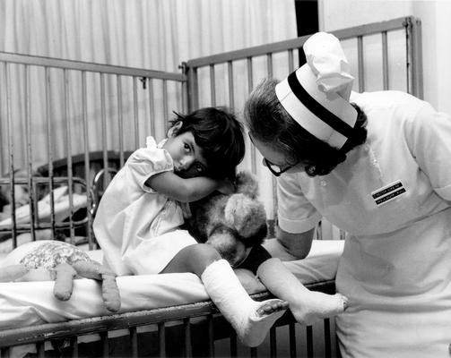 Cardinal Hill Hospital; Nurse comforts girl from #447