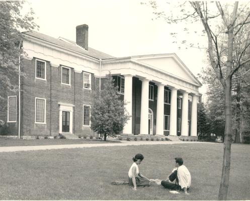 Centre College; A couple sit on the lawn in front of the Centre College Administration Building