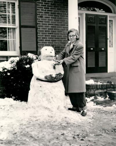 Children; Teen builds a snowman