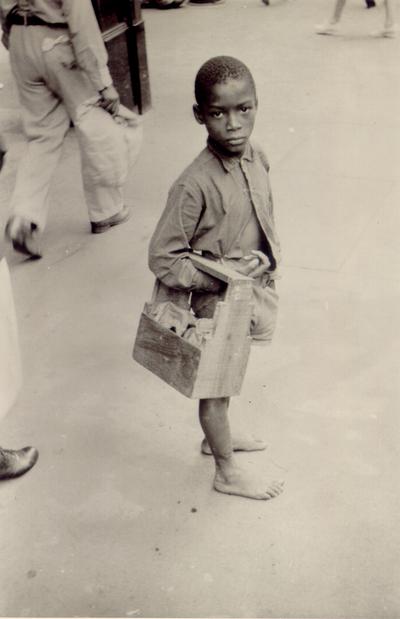 Children; A young barefoot African-American boy