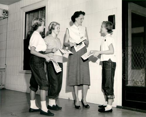 Children; A woman and three young girls with campaign ads