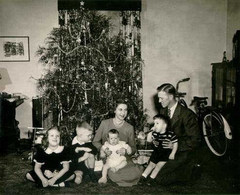 Children; A family of six by their Christmas tree