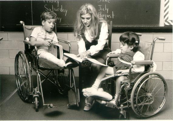 Children; In the Hospital; A teacher reads to two children