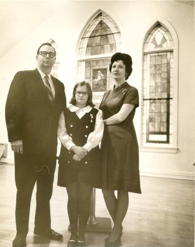 Churches; Choirs and Congregations; A family of three inside a church