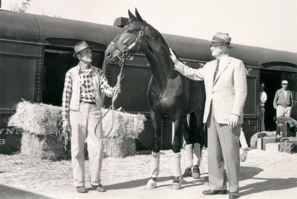 Combs, Leslie; Leslie Combs petting a horse