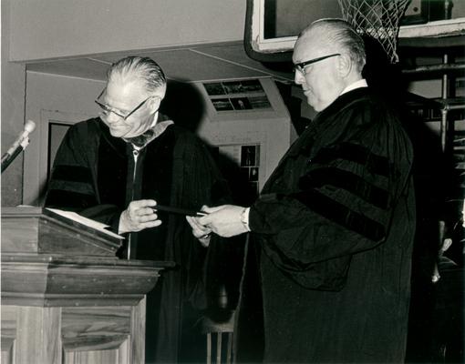 Commencements; Two collegiate dignitaries at the podium