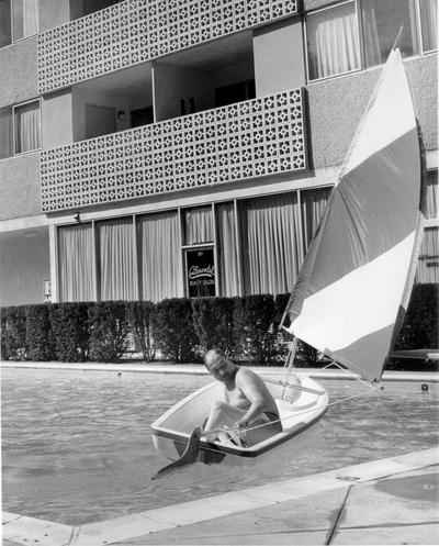 Continental Inn; Man in sailing in motel pool