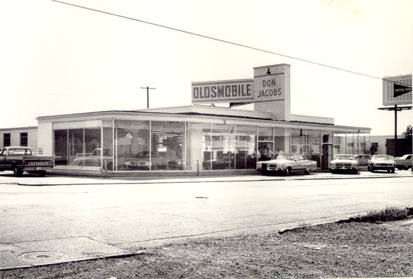 Don Jacob's Oldsmobile; Salesmen at the showroom entrance