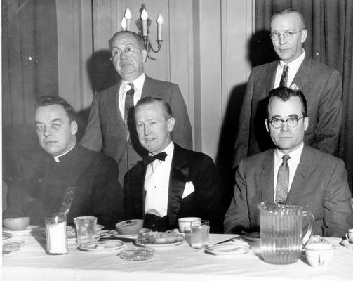 Groups; Unidentified; Four businessmen and a priest at breakfast