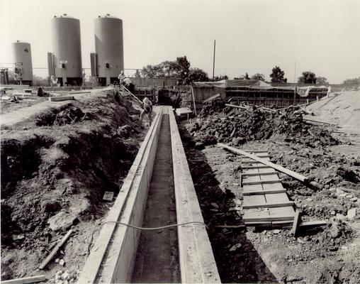 Georgetown; Clark Equipment Co.; Construction; Construction worker checking on concrete drainage for workmanship