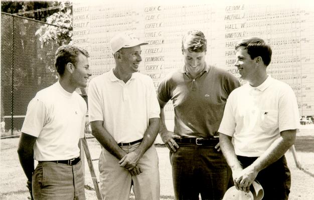 Golf; Four golfers in front of the clubhouse score card (similar to #942)