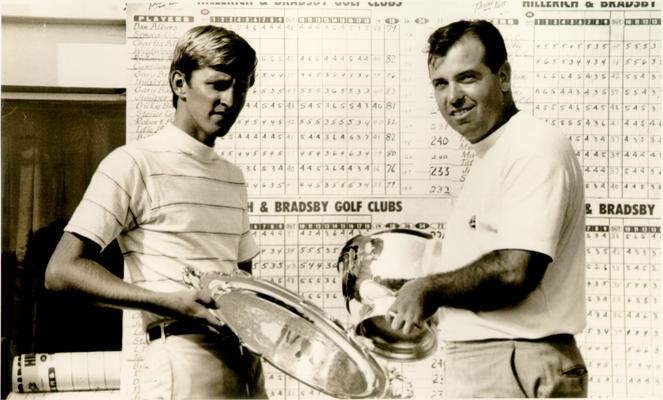 Golf; Two trophy winners in front of the score card