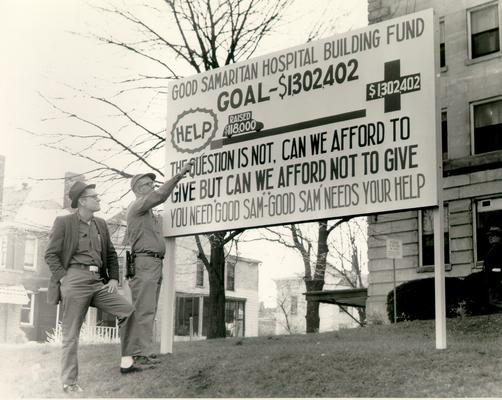 Good Samaritan Hospital; Building Fund; Two men look at the fund-raising sign