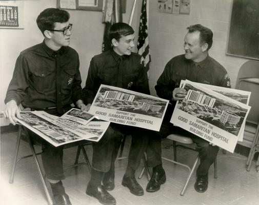 Good Samaritan Hospital; Building Fund; Three men in uniform holding building fund campaign posters