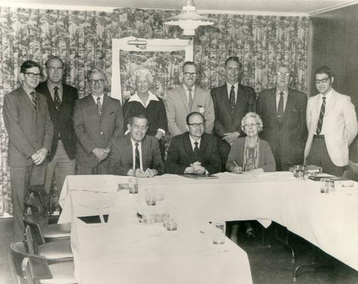 Groups; Unidentified; Associates gathered around a u-shaped table