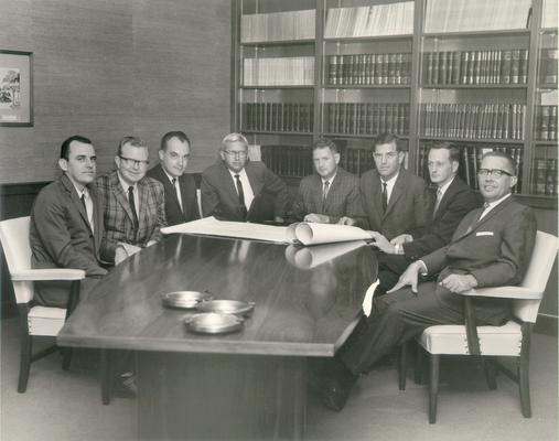 Groups; Unidentified; A group of men looking over blue prints