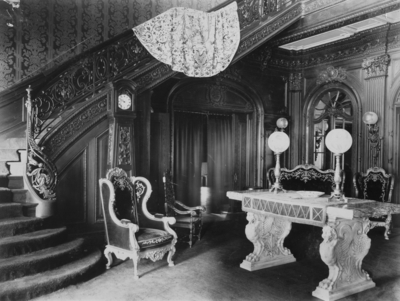 Entrance Hall; Interior of Elmendorf Farm Mansion; staircase leading to second floor, ornately furnished room, marble table with lamps and chairs. Silver Print