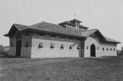 Breeding Barn; Exterior of building, large building with two oversized doors visible, windows dot the first and second floors. Silver Print
