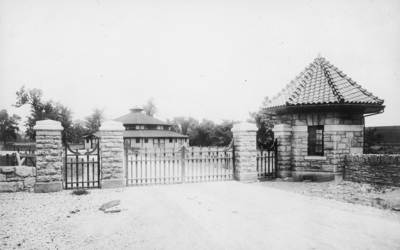 A gate with security house. Silver Print