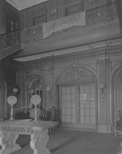 Interior of the Entrance Hall of Elmendorf Mansion; shows marble table with two lamps. Silver Print
