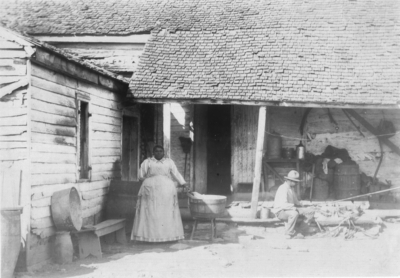 Posed photo; An African American couple in front of their house. Silver Print