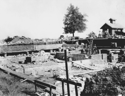 Construction site; Early stage in the construction of the Elmendorf Farm Mansion, building implements scattered throughout site. Silver Print