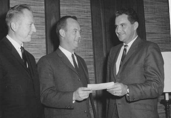 Creech, Glenwood L., Alumnus, B.S., 1941; M.S., 1950, Vice President of University of Kentucky Relations and Professor of Extension Education, Research Specialist in Vocational Education, 1965 - 1973, President of Florida Atlantic University, 1973 - 1983, pictured receiving grant from IBM