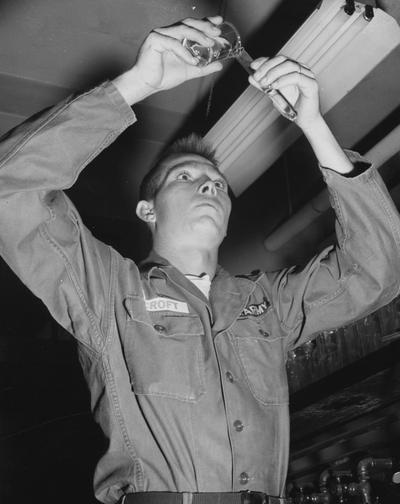 Croft, Randall C., Alumnus, Reserve Officer Training Corp, pictured as Private First Class Randall C. Croft pours acid into a test tube during Chemistry Lab experiment at the Army Education Center in Fort Knox, Kentucky