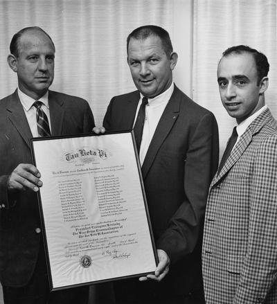 Drake, Robert M., Jr., Professor, Mechanical Engineering, Dean, College of Engineering, pictured at left with two unidentified individuals holding certificate from Tau Beta Pi (National Engineering Honorary Society) for Alumni members in good standing, April 4, 1968