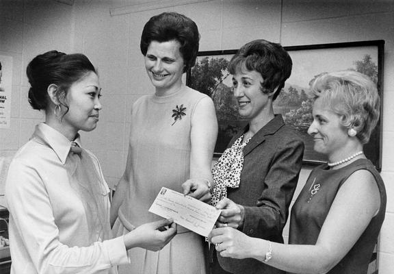Fendley, Estella, Assistant Advisor for International Students, pictured (left) accepting a donation to the Nell Donovan International Student Loan Fund from Mrs. Robert Kiser, Mrs. Daniel Arnold and Mrs. William Peters, May 25, 1971, Public Relations Department