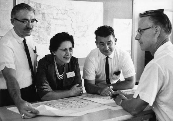 Field, Thomas, Professor, Geography Department, pictured (far right) with three unidentified individuals